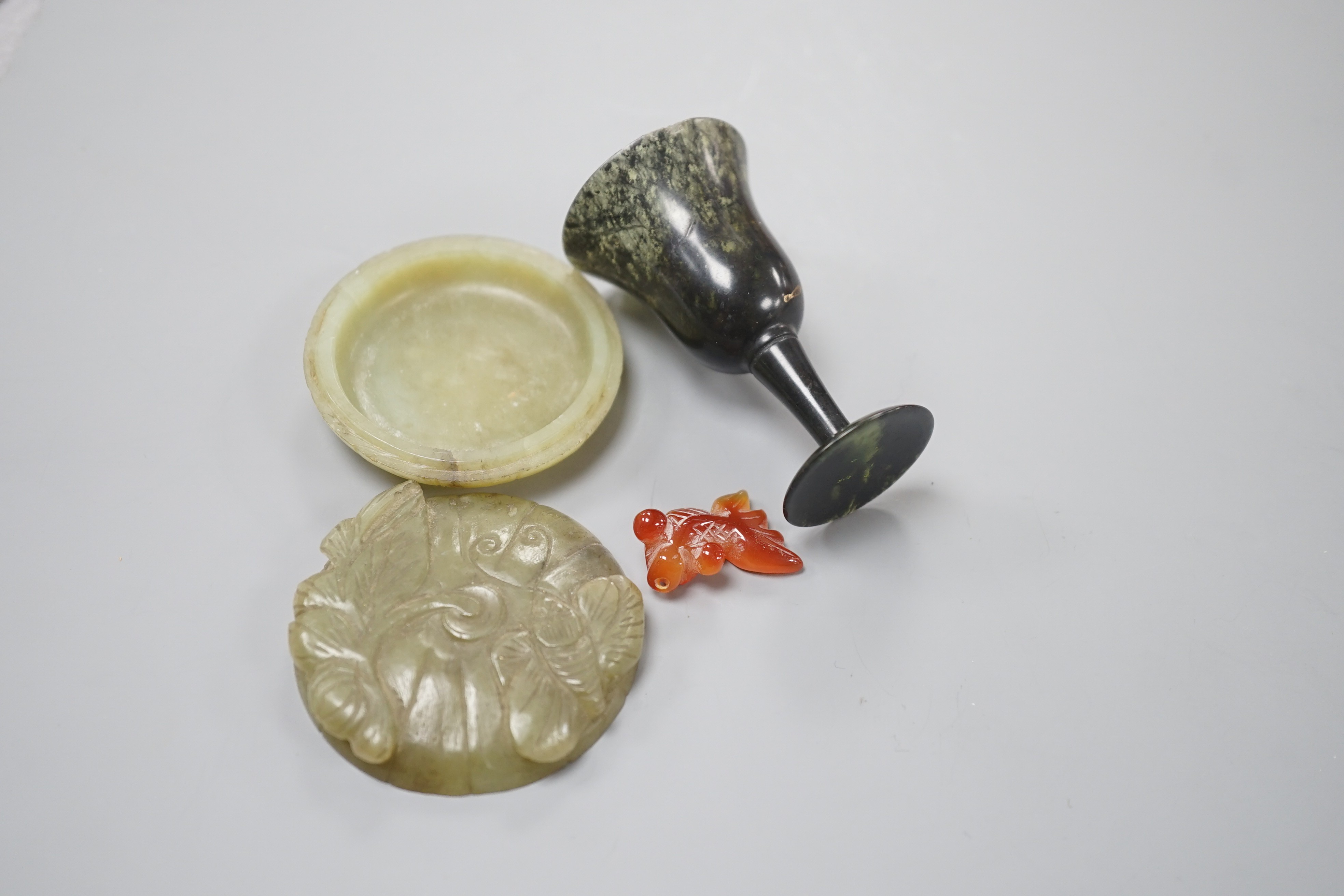 A Chinese green jade ‘butterfly’ box and cover, a moss agate cup, cup and an agate fish, largest 7cms high.